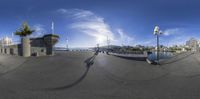 the reflection of a man on a skateboard in front of a bridge and buildings