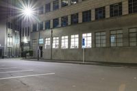 an empty parking lot at night with the sun on top of a building in the background