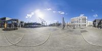 a fish eye view of the harbor on a sunny day with clouds in the sky