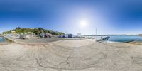 a fish eye view of an empty pool surrounded by trees and water and a lighthouse