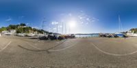 the sun shines through a circular lens view of a marina with boats on a small island