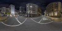 a street view of buildings and other buildings in the night sky, including one of them a stop light