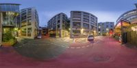 two fish eye photographs showing a city street and people walking on it in the evening