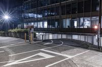 a car drives down the road in front of some tall buildings at night time with bright street lights