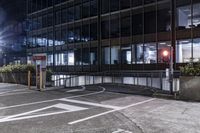 a car drives down the road in front of some tall buildings at night time with bright street lights