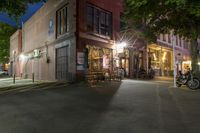 a cafe at night and a parked motor scooter in front of the building