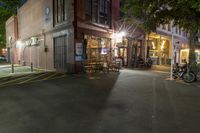 a cafe at night and a parked motor scooter in front of the building