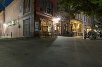 a cafe at night and a parked motor scooter in front of the building