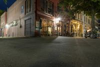 a cafe at night and a parked motor scooter in front of the building