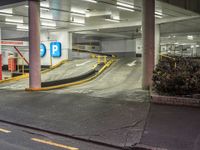 a parking garage area with a long ramp next to it and yellow lines on the floor