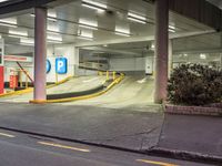 a parking garage area with a long ramp next to it and yellow lines on the floor