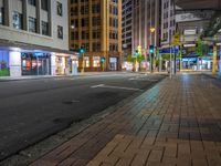 the streets of city are deserted at night as people walk across the street in front of buildings