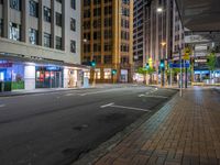 the streets of city are deserted at night as people walk across the street in front of buildings