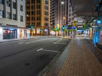 the streets of city are deserted at night as people walk across the street in front of buildings