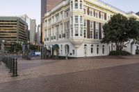 the buildings on this street have ornate architecture, like a large building with arched windows