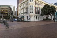 the buildings on this street have ornate architecture, like a large building with arched windows