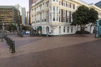 the buildings on this street have ornate architecture, like a large building with arched windows