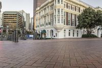 the buildings on this street have ornate architecture, like a large building with arched windows