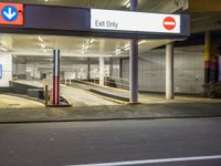 the exit only sign is shown in front of a bus station loading area for people to use