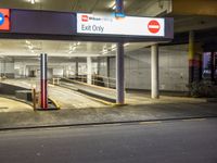 the exit only sign is shown in front of a bus station loading area for people to use