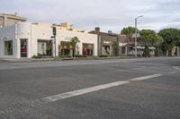 an empty street with several businesses lined up along it's sides, and no vehicles in view