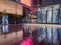 this is an image of a wet city streets at night in the rain - covered ground