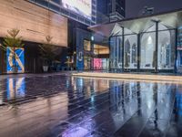 this is an image of a wet city streets at night in the rain - covered ground