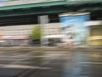 traffic is passing in a blurry view on a busy intersection on a city street