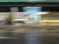 traffic is passing in a blurry view on a busy intersection on a city street