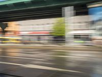 traffic is passing in a blurry view on a busy intersection on a city street