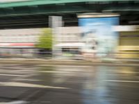 traffic is passing in a blurry view on a busy intersection on a city street