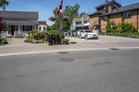 a white car is parked on the side of the road beside a building with a store front