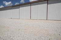 there is a white fence in front of a garage door with red trim and large windows