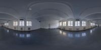 a fish eye view of an empty white room with windows and floors and ceilinging