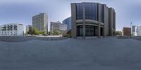 the large building is in a very wide angle on a sunny day and it's half empty