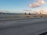 a very wide bridge with a view of the ocean in the background in the foreground