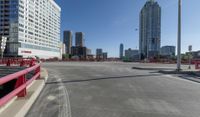 a wide city street with tall buildings near it on a sunny day during the day