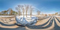 a view from the bottom of a very wide fish eye lens of a road and road in the winter