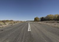 an empty road with lines and no vehicles on it is very wide open space for people