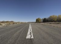 an empty road with lines and no vehicles on it is very wide open space for people
