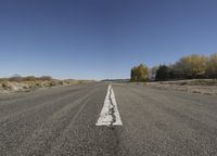 an empty road with lines and no vehicles on it is very wide open space for people