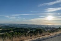 there are many clouds above the horizon and mountains in this picture of a wide open road