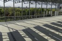 a photo of a very wide outdoor stage overlooking the skyline while someone is using a cell phone