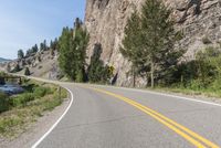 the winding road winds its way towards a mountain top on a clear day on a sunny, blue sky