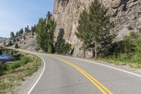 the winding road winds its way towards a mountain top on a clear day on a sunny, blue sky