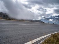 Winding Road Through Highlands with Grey Sky Drama