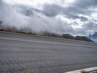 Winding Road Through Highlands with Grey Sky Drama