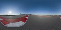 360 - view of a track with lines and red paint on it on the road