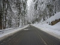 Winding Road Through Snowy Landscape of Mountains and Forest