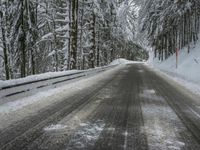 Winding Road through Snowy Landscape with Mountains and Forest